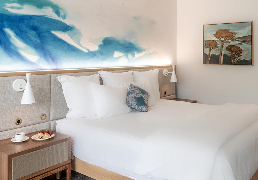 Portola Hotel guest room with a bed.