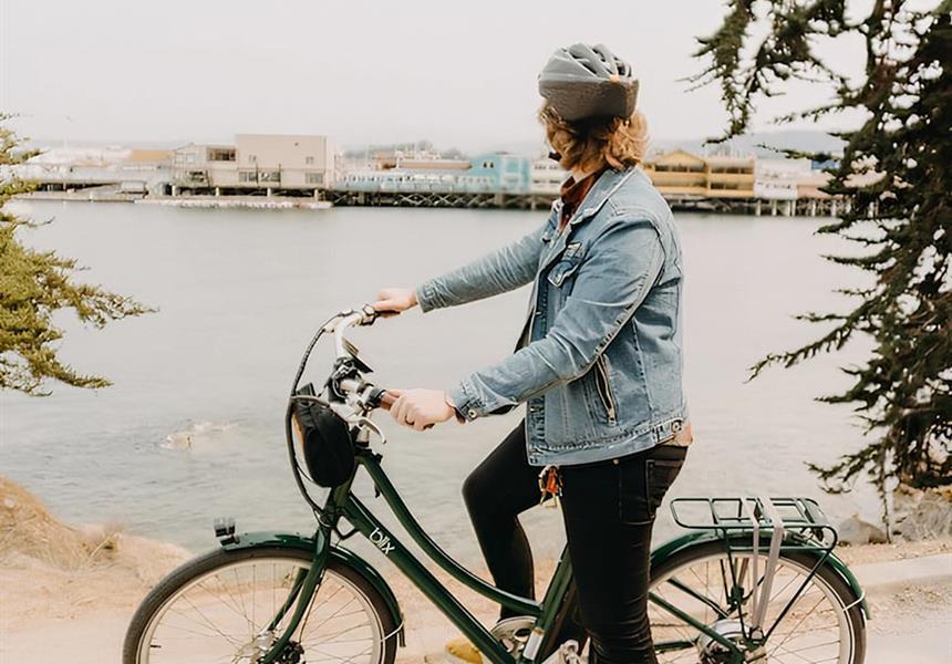 Woman riding bicycle in Monterey.