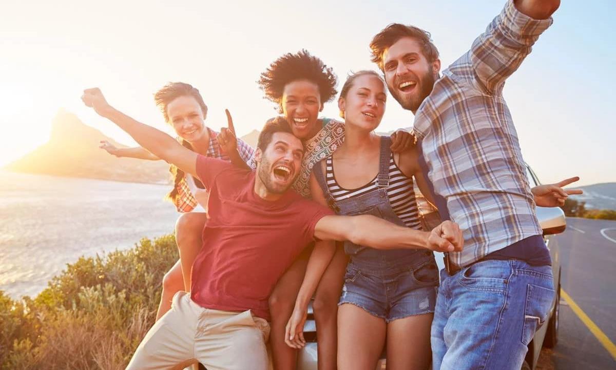friends taking a photo by the beach