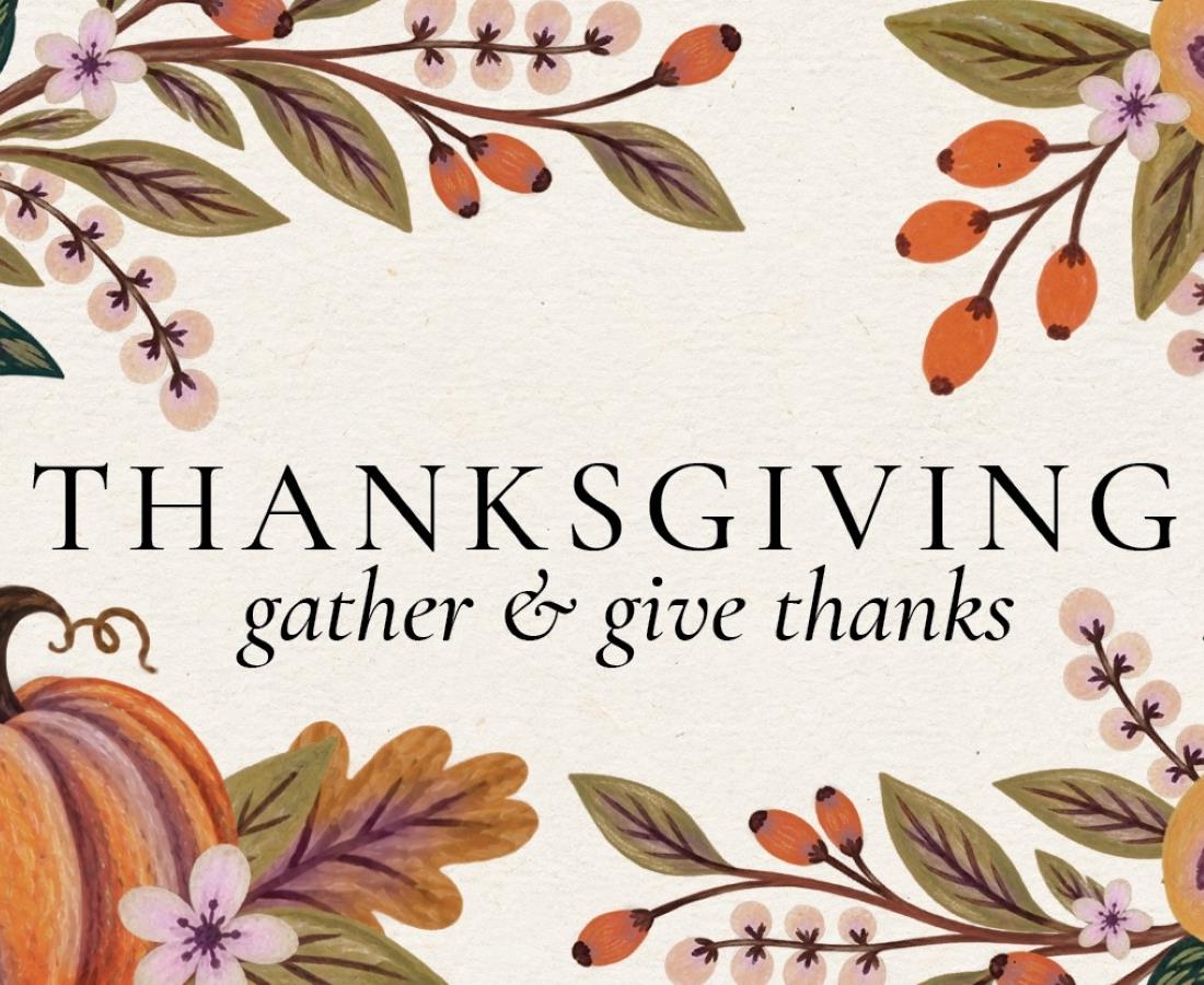 Give Thanks text over a white background with pumpkin and leaves in the background